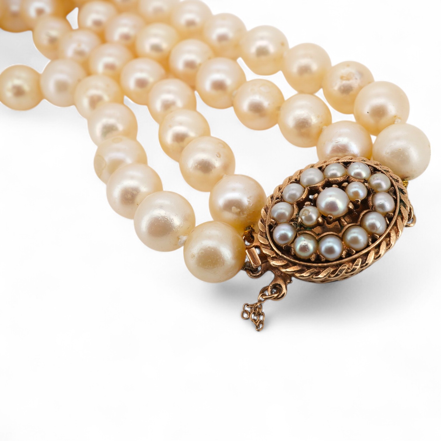 A double strand cultured pearl necklace, with a 9ct gold and cultured pearl cluster set clasp, pearl diameter approximate range 8.4mm-9mm.